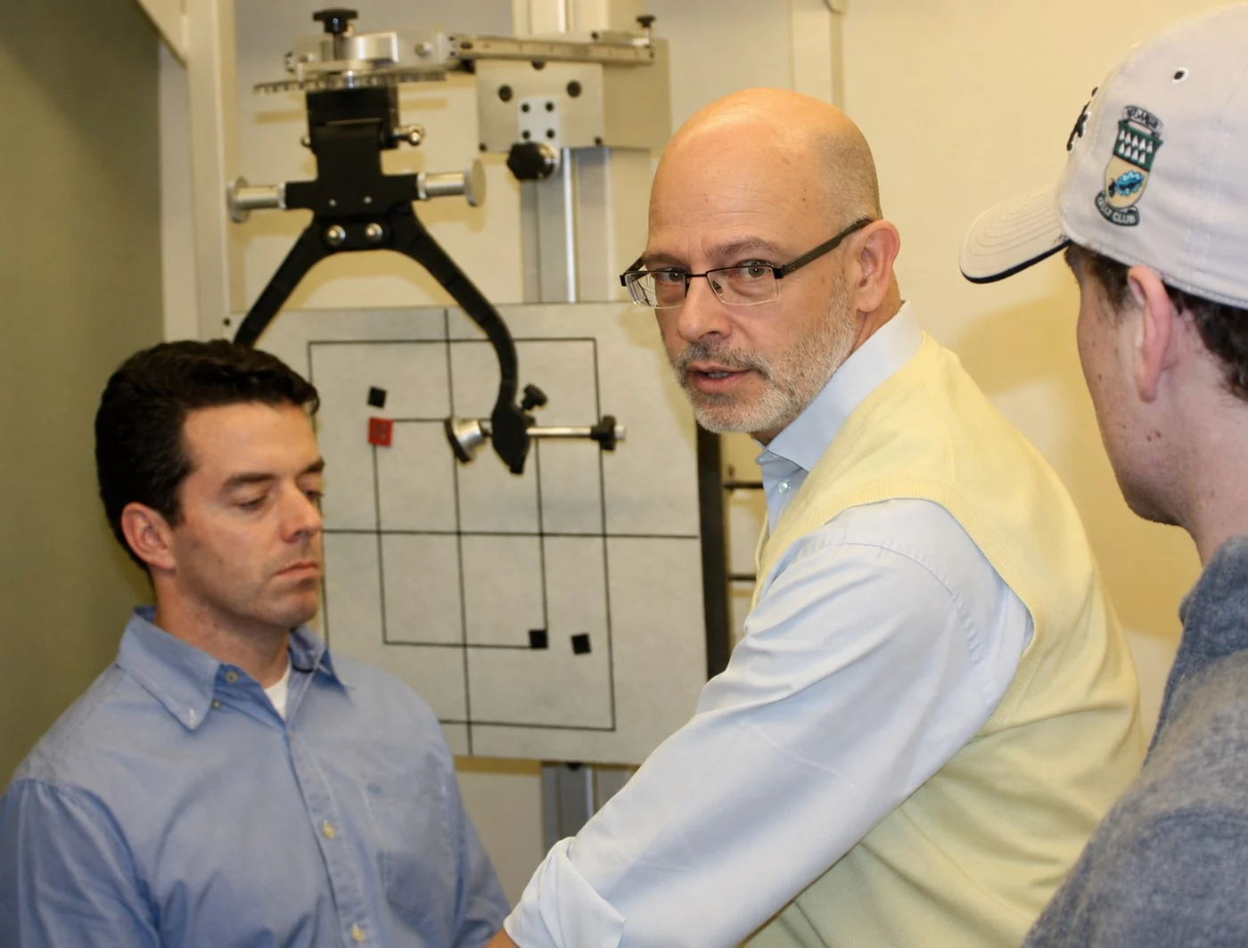 Dr. Lenarz instructing two chiropractors at upper cervical imaging equipment